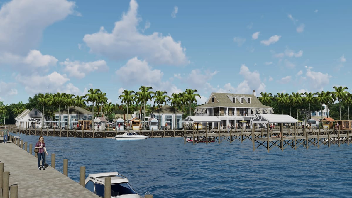 Waterfront scene with wooden pier, boats, buildings, and palm trees under a partly cloudy sky.