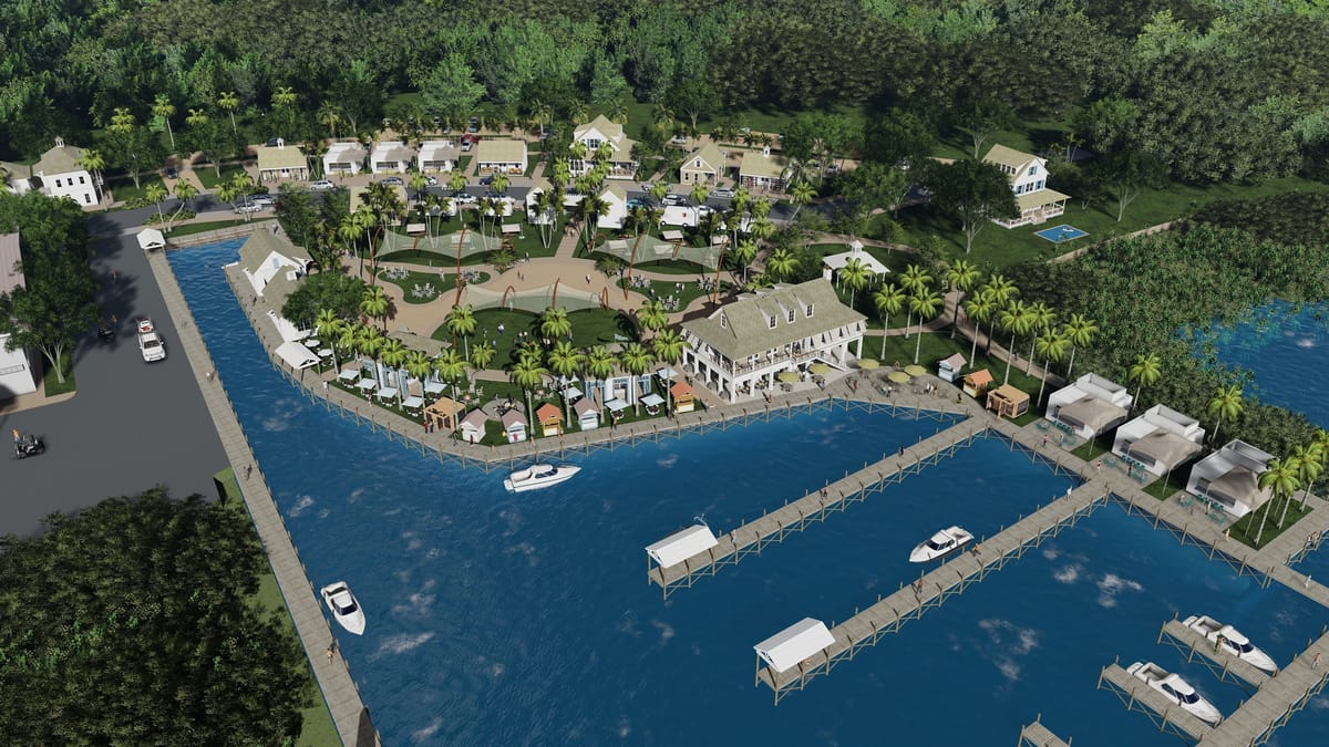 Aerial view of a waterfront community with marina, boats, paths, palm trees, and residential buildings.
