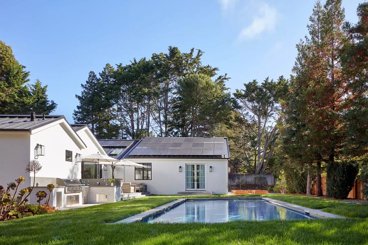 Exterior rear view with swimming pool, grass lawn, patio, outdoor furniture, and barbeque grill