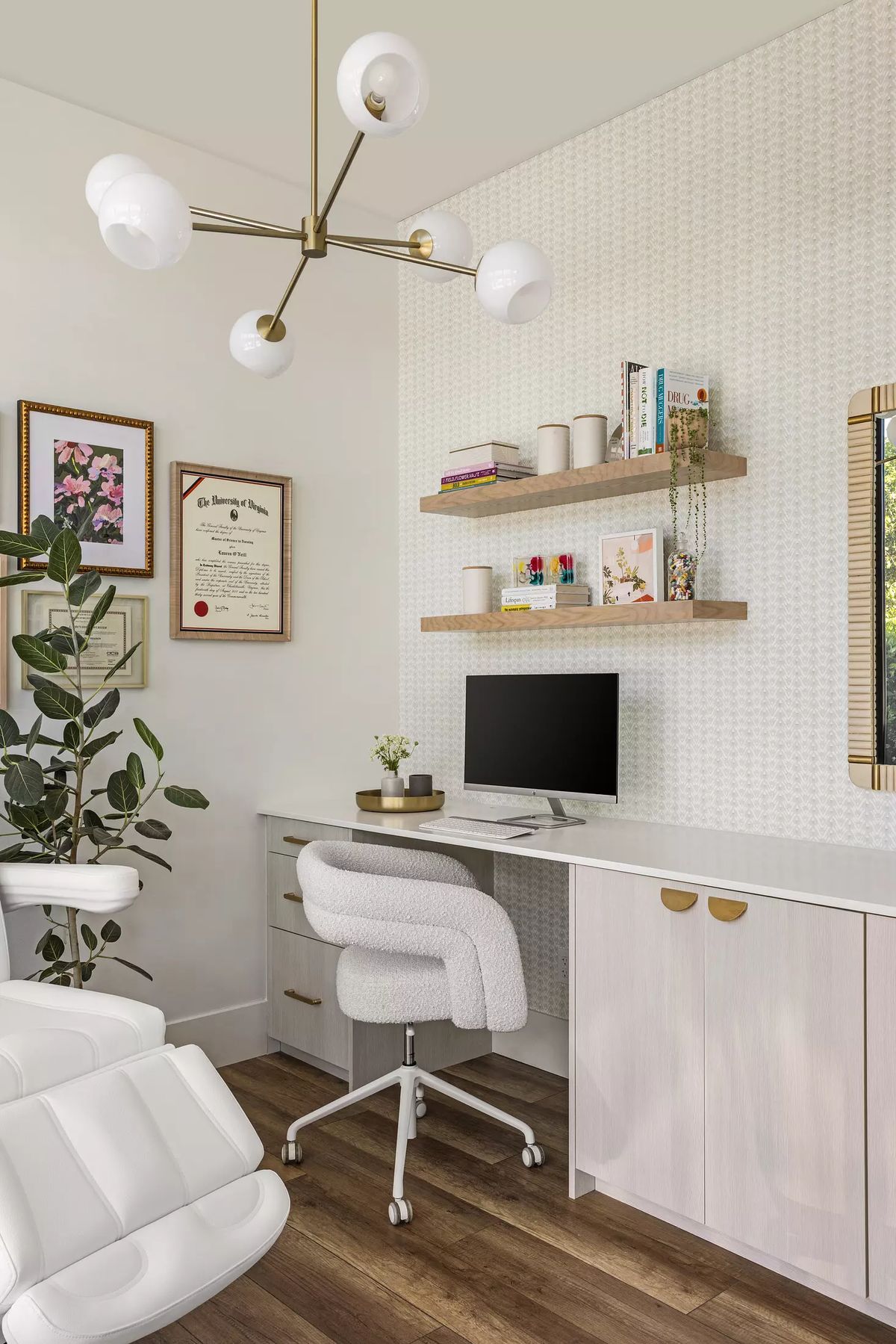 Office with white desk, computer, swivel chair, wooden shelves, plant, and wall-mounted mirror