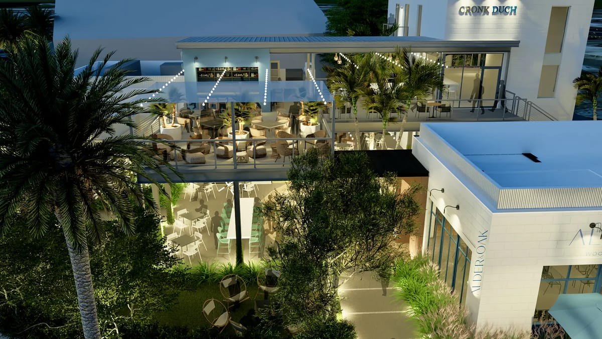 Exterior view of a multi-level dining area with outdoor seating and surrounding greenery.