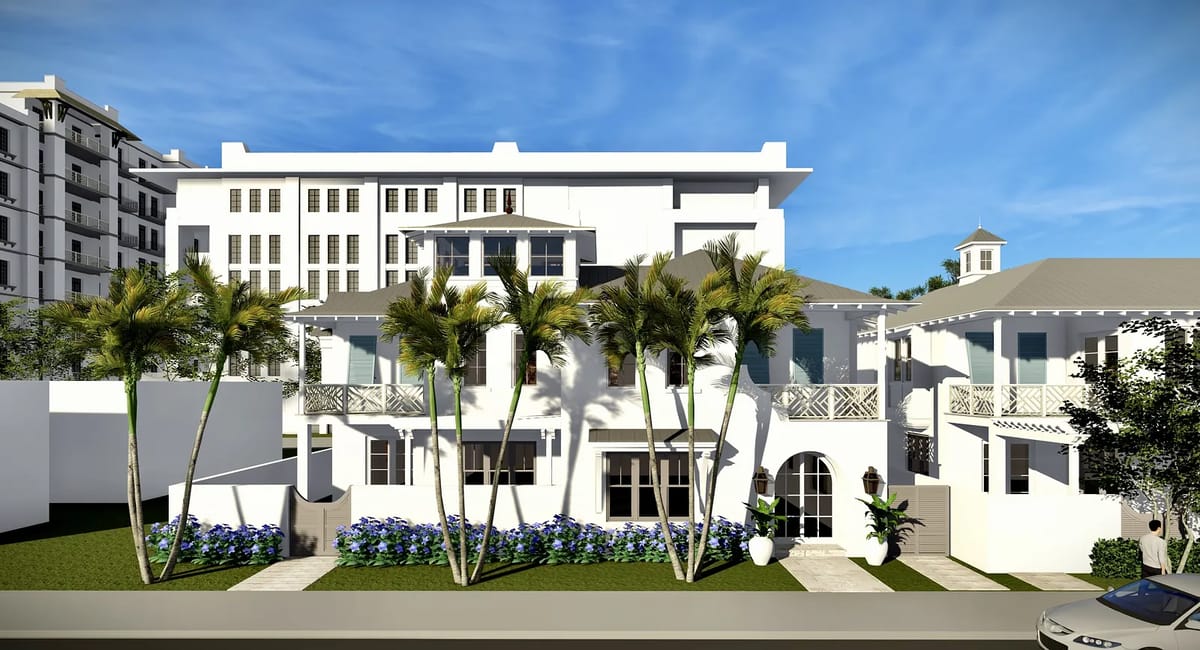 Exterior front of a house with white facade, landscaping, windows, and palm trees.