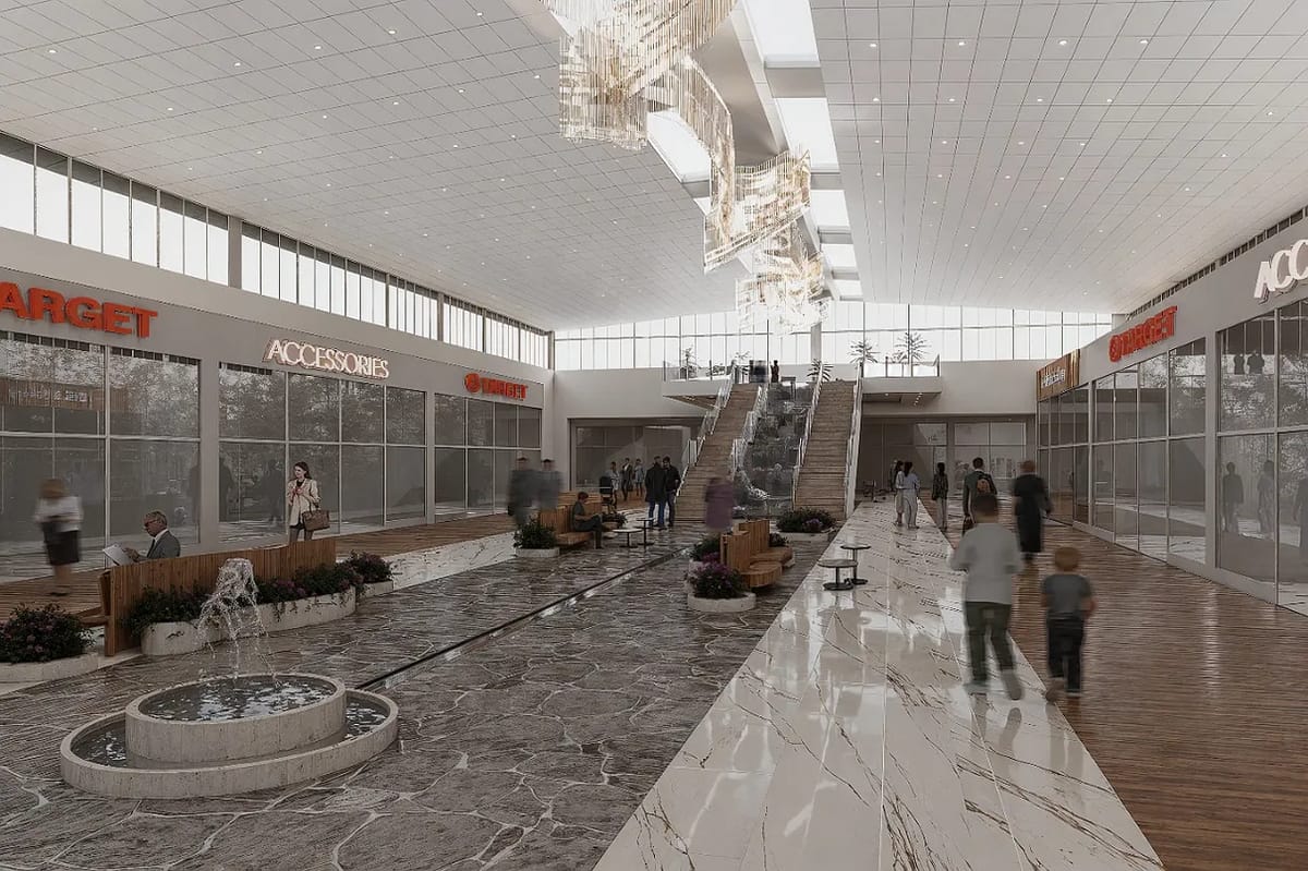 Shopping space with large windows, escalators, water feature, stone flooring, and retail signage.