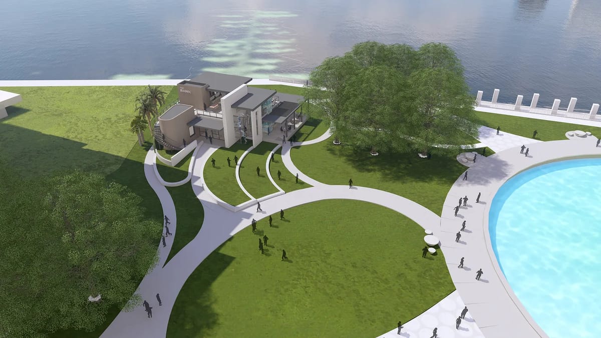 Outdoor space with modern building, landscaped lawn, pathways, and swimming pool beside large body of water.