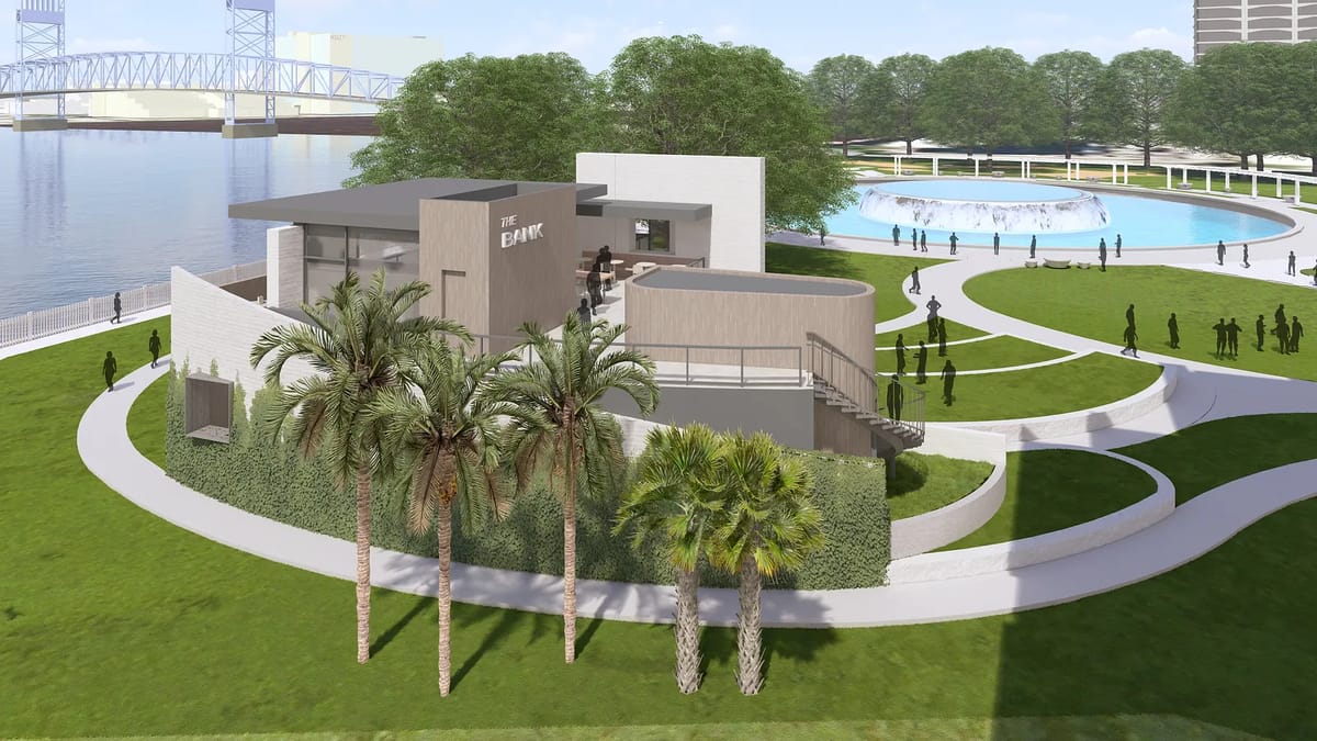 Exterior view of a modern building with landscaped lawns and a nearby water fountain.