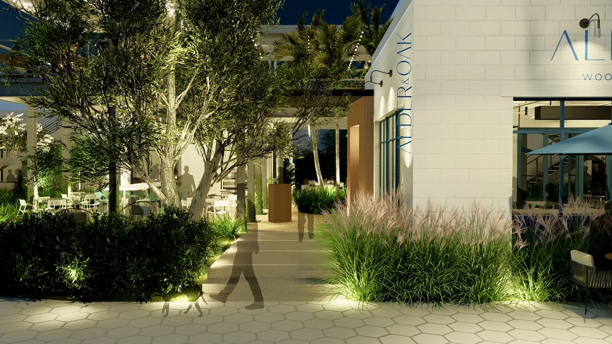 Exterior front view with landscaped pathway, greenery, building entrance, and decorative lighting.