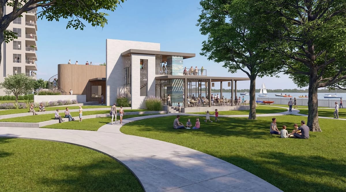 Outdoor area with landscaped lawn, curved pathways, modern building, and people enjoying leisure activities.