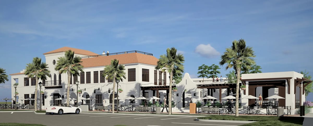 Exterior front view of a two-story building with red tile roof, palm trees, and patio area with tables and umbrellas.