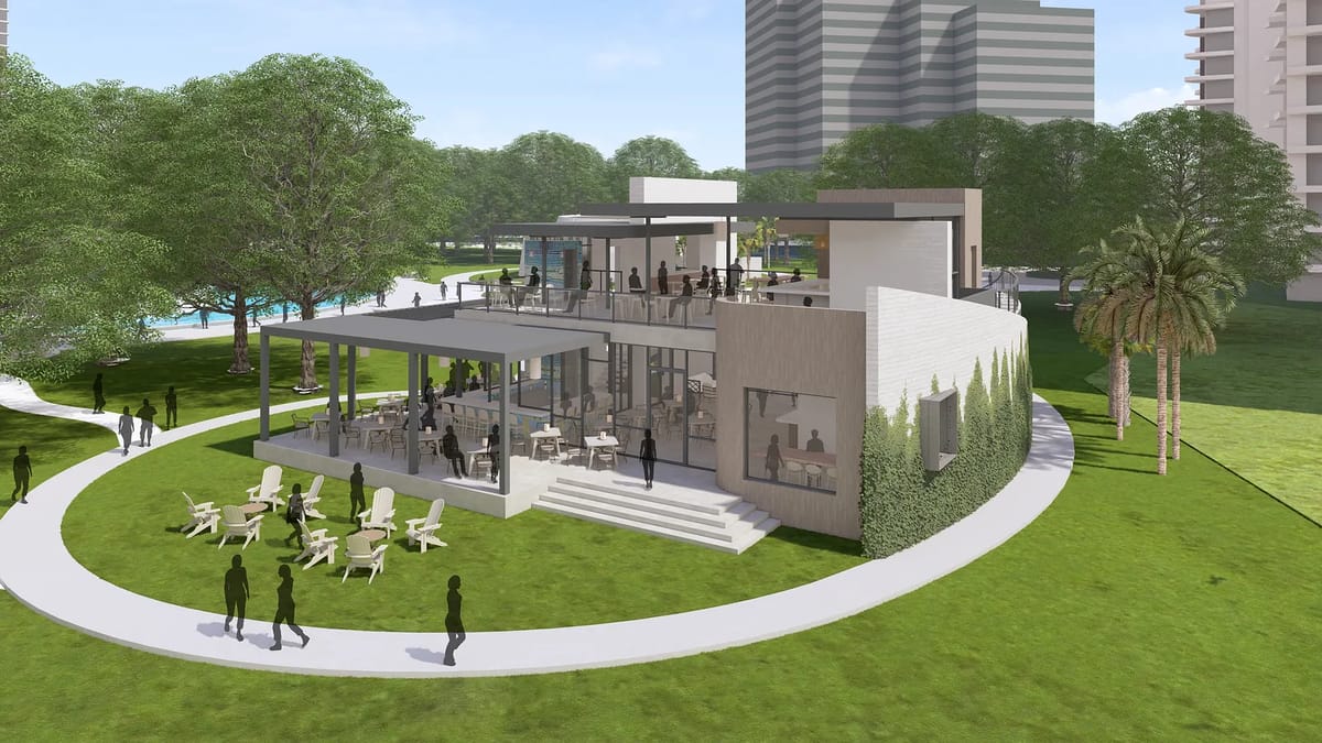 Exterior view of a multi-story building with glass windows, balconies, and outdoor seating.