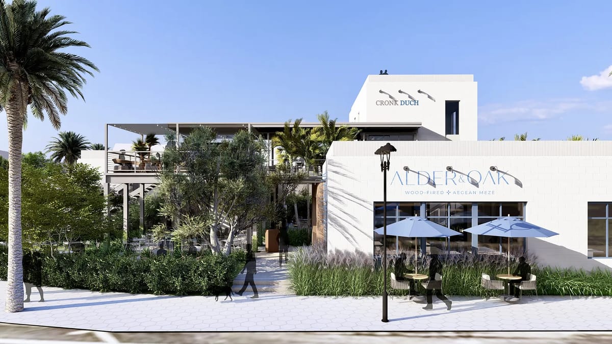 Exterior view of a commercial building with outdoor seating, palm trees, and a balcony terrace.