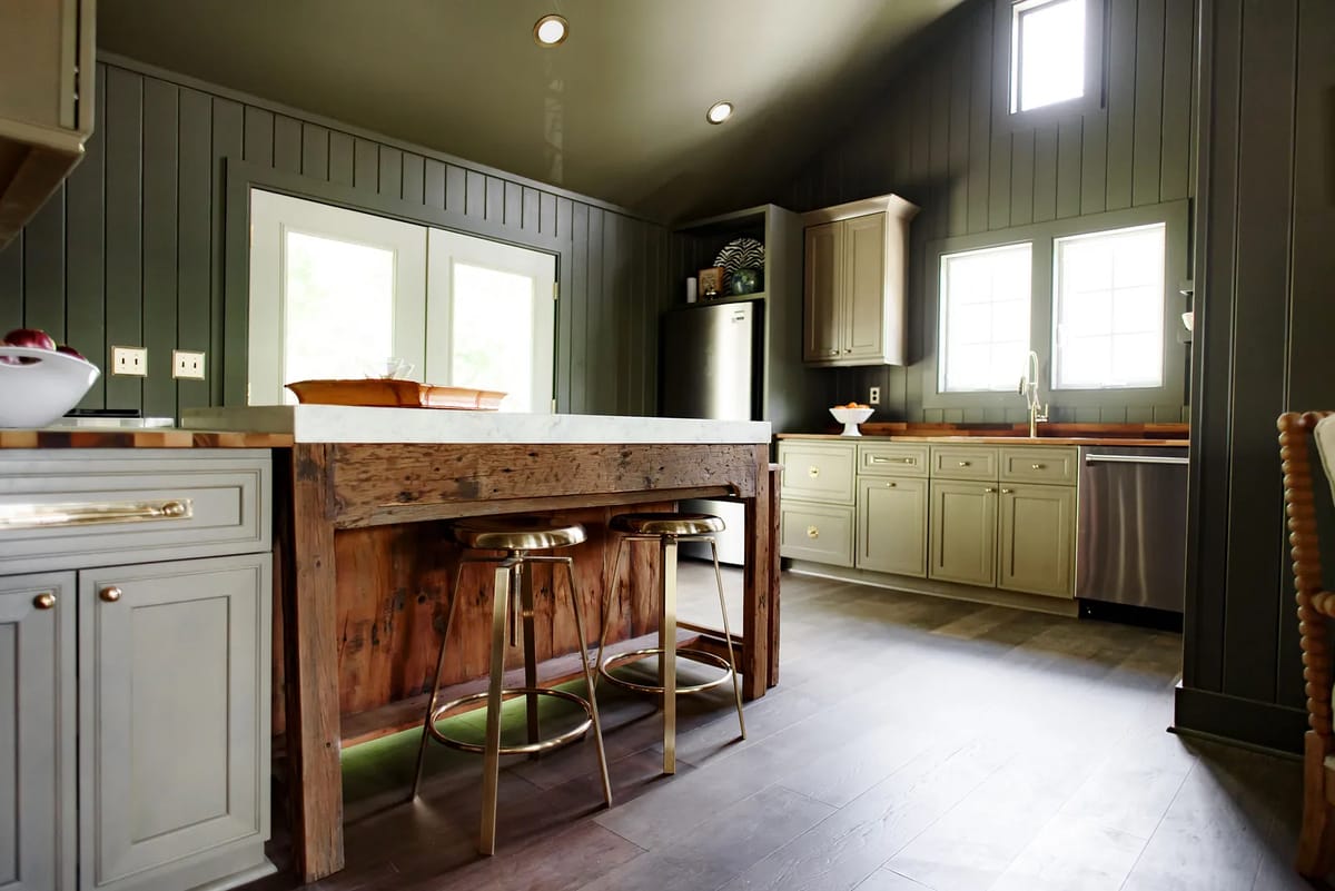 Kitchen with central island, gray cabinetry, stainless steel appliances, double windows, and dark hardwood flooring