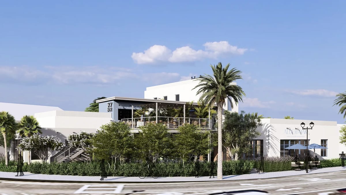 Exterior front view of a two-story building with terrace, large windows, palm trees, and surrounding greenery.