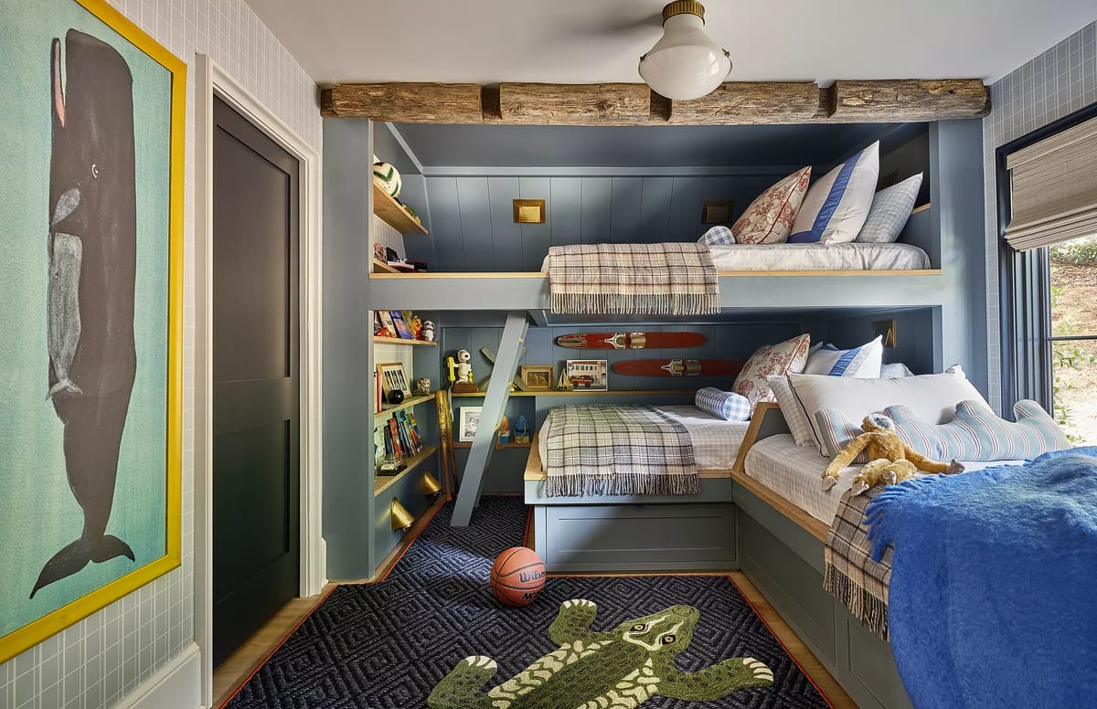 Bedroom with bunk beds, blue rug, whale painting, wall shelving, teddy bear, and basketball