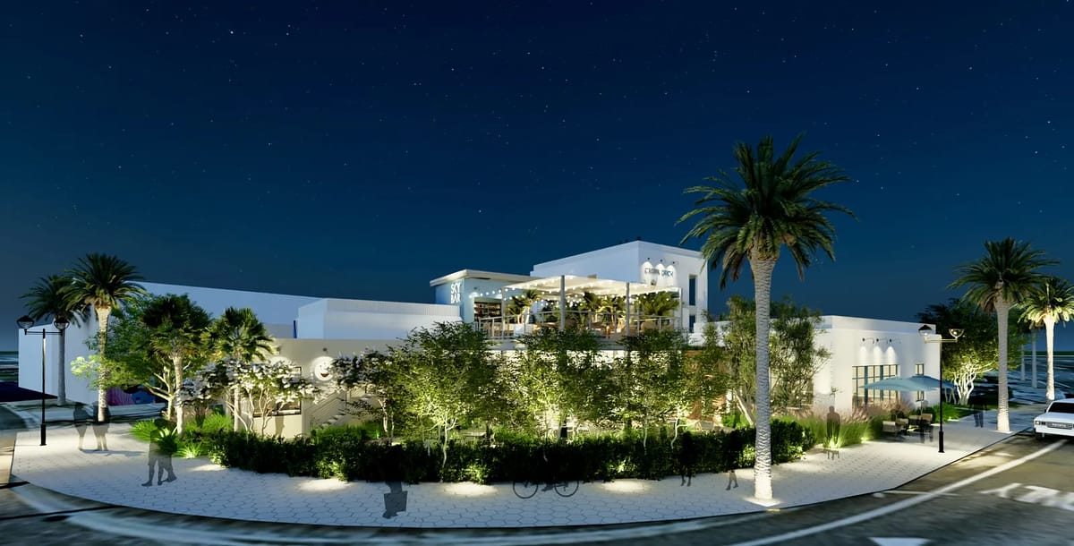 Exterior view of a modern building with large windows, balconies, palm trees, and landscaped areas.