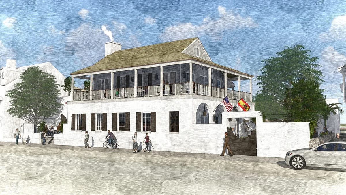 Exterior front of a two-story building with porch, flags, people, car, and greenery.