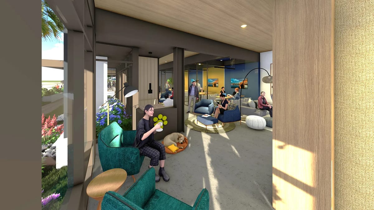 Living room with teal armchairs, wooden table, poufs, dog bed, and large windows with natural light.