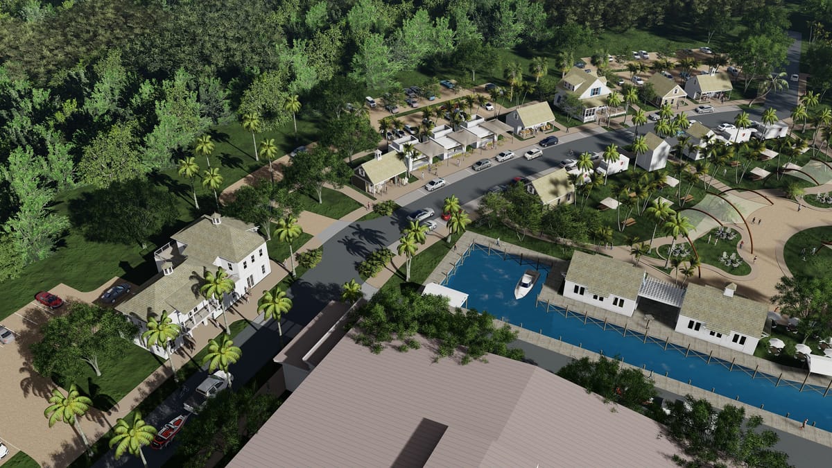 Aerial view of residential buildings, pathways, parking area, and a blue waterway with boats.