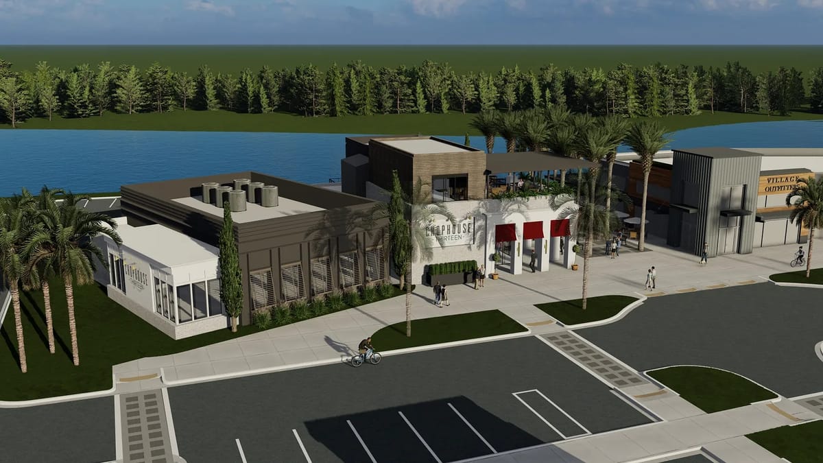 Exterior view of a building complex with diverse structures, parking spaces, palm trees, and a water body.