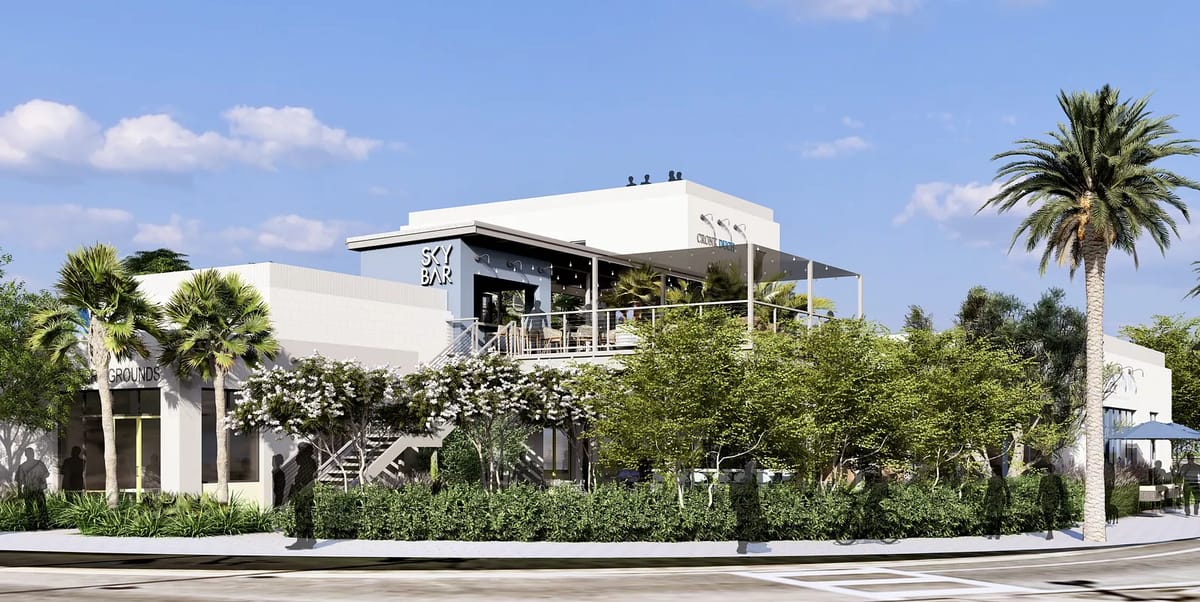 Exterior view of a building with terrace, palm trees, and modern architecture featuring 'Sky Bar' signage.