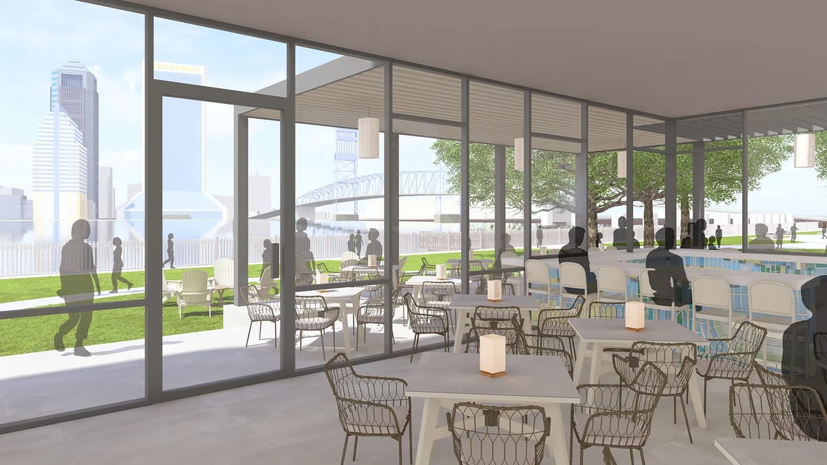Outdoor patio with round tables, chairs, bar counter, and glass windows overlooking greenery.