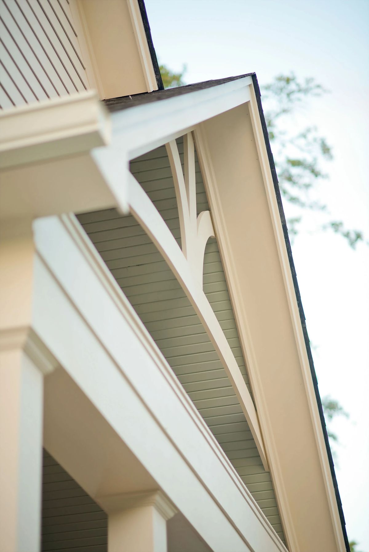 Close-up of exterior architectural features with eaves and wood siding.