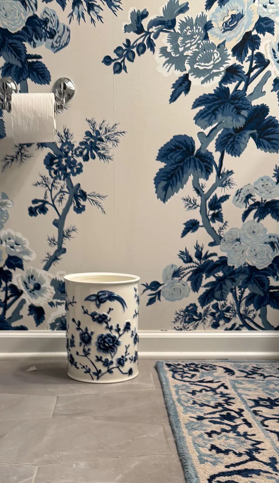 A small unique Garbage can makes the difference in this powder room