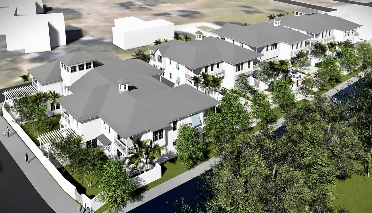Exterior front view of residential buildings with pitched roofs, balconies, and landscaped gardens.