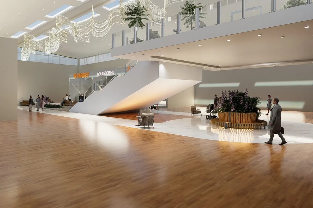 Open foyer with wooden floor, staircase, seating areas, and large glass windows.