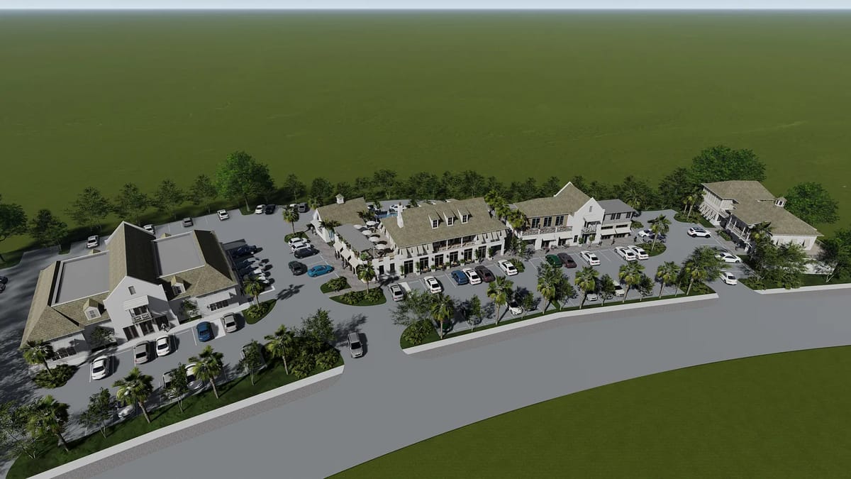 Exterior view of a commercial complex with multiple buildings, parking, and landscaping.