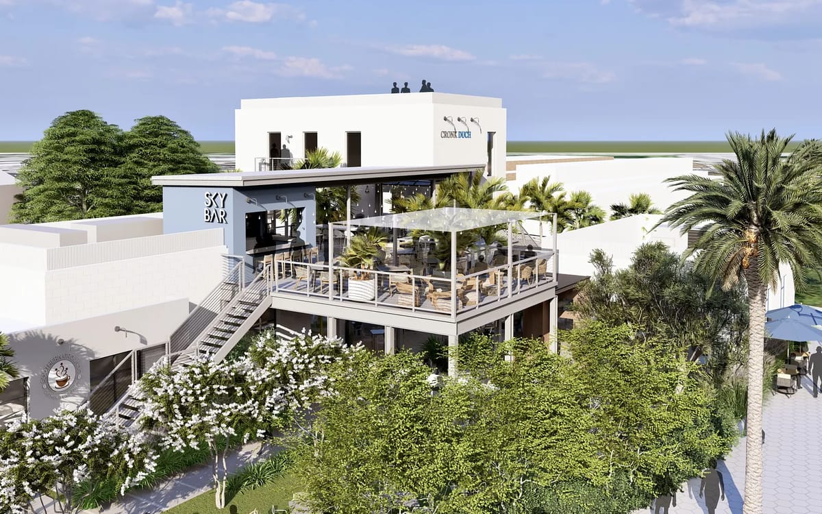 Multi-level building with terrace, outdoor seating, palm trees, and modern white exterior.