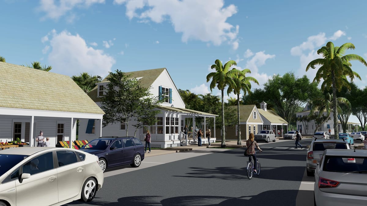 Streetscape with houses, parked cars, trees, and people walking and biking.
