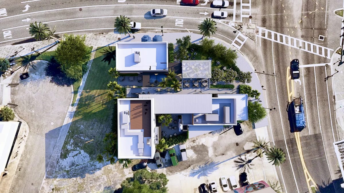 Aerial view of property layout with buildings, gardens, pathways, and parking areas.