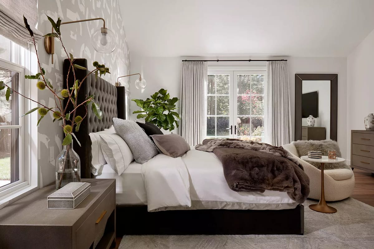 Bedroom with black platform bed, white bedding, nightstand, dresser, large window, and area rug.