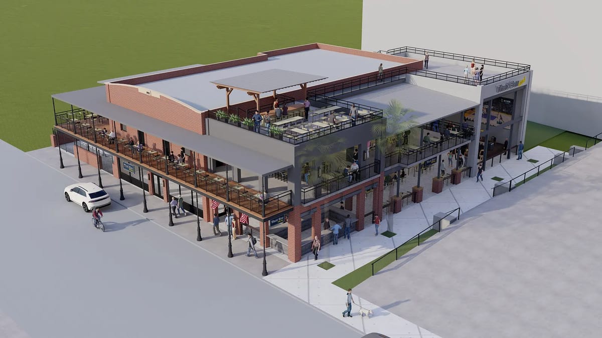 Exterior view of a multi-level commercial building with outdoor seating, large windows, and a rooftop terrace.