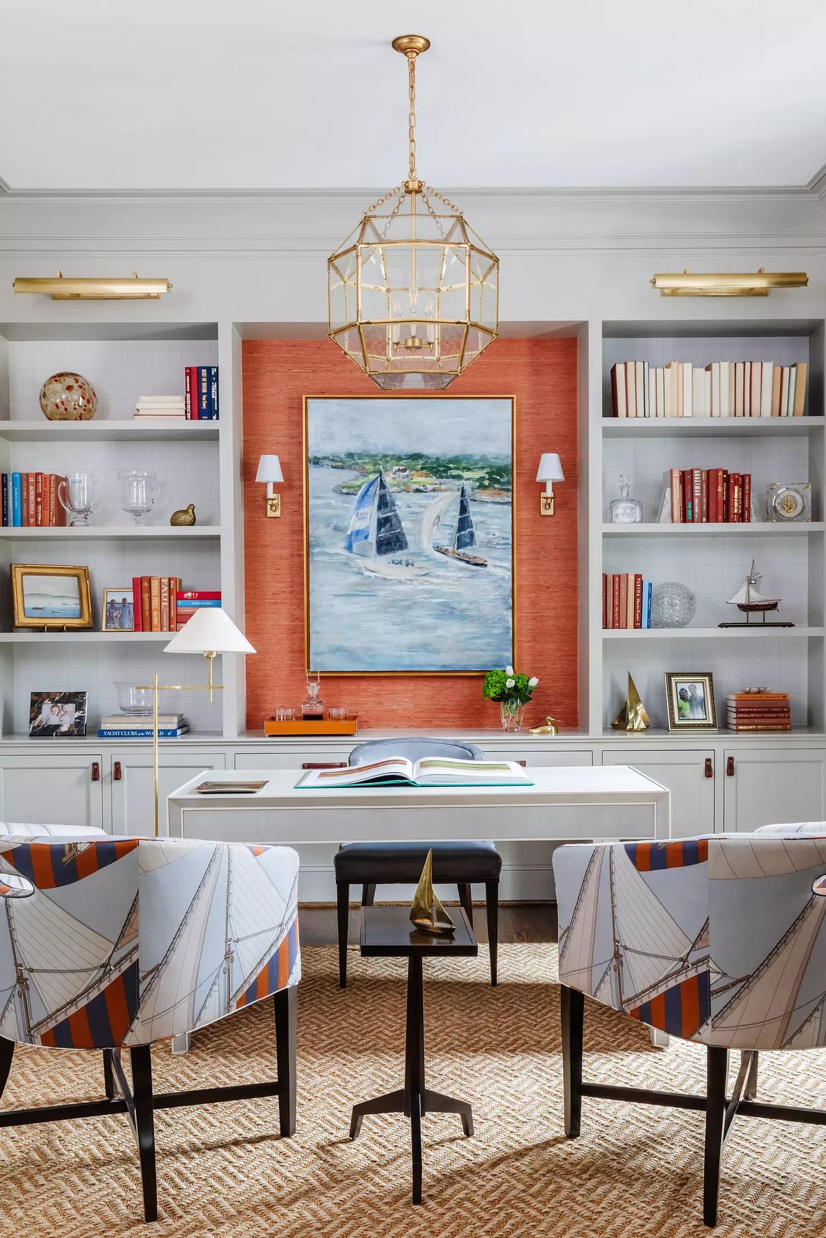 Office with structured desk, patterned chairs, bookshelves, large artwork, and textured rug