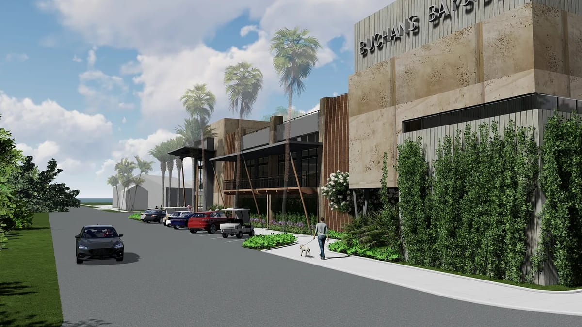 Commercial building exterior with stone façade, large windows, palm trees, and parked cars.