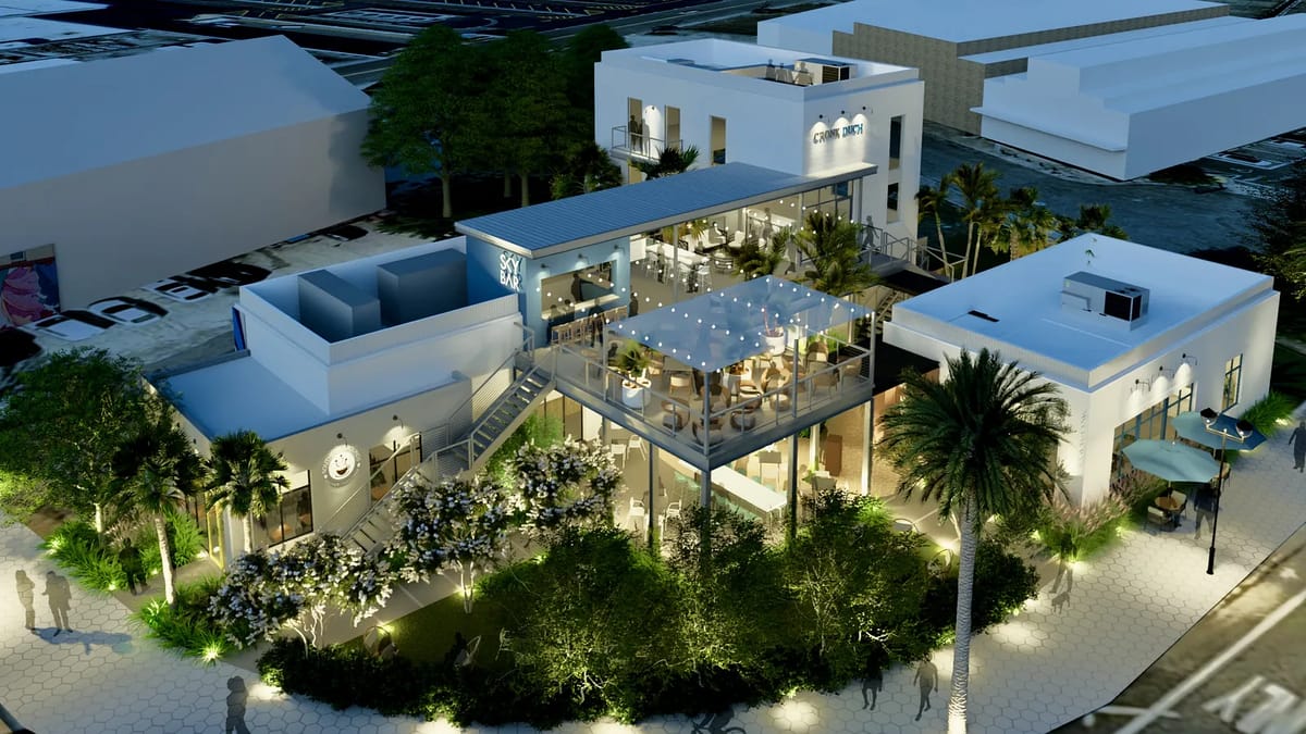 Exterior view of a modern multi-level building with windows, terrace, lighting, and landscaping.