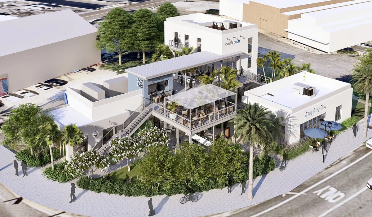 Exterior view of a multi-level building with white facade, large windows, greenery, and rooftop terrace.
