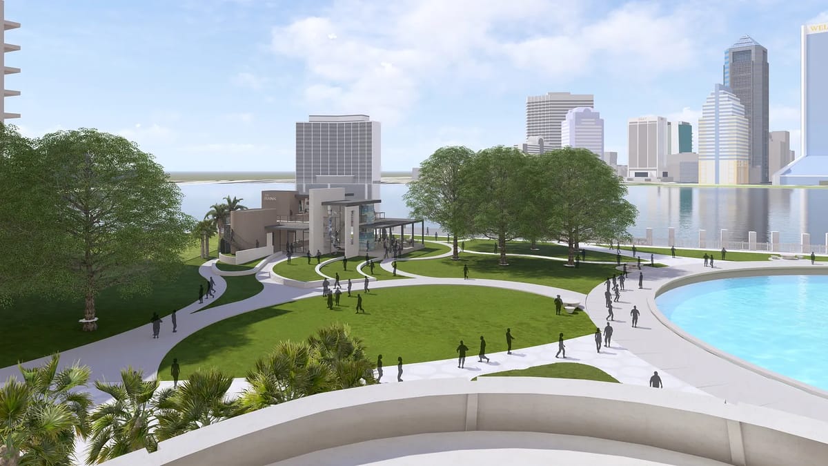 Outdoor garden with grassy area, paved paths, trees, and people walking