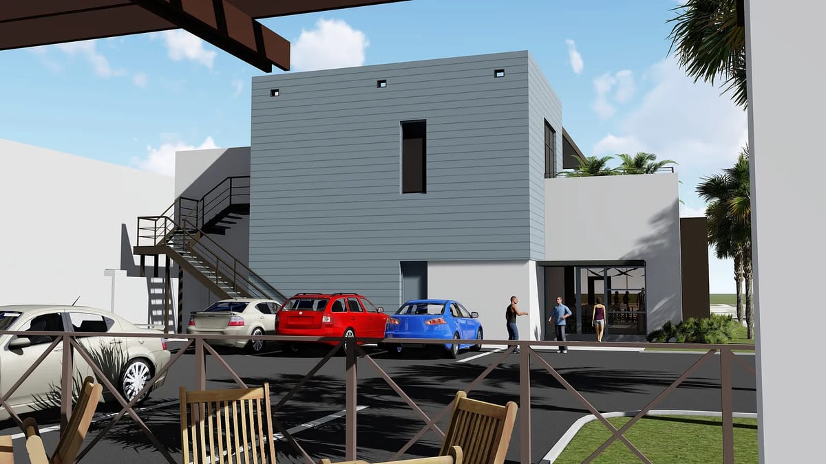 Exterior view of a building with white and gray sections, cars parked, and people walking nearby.