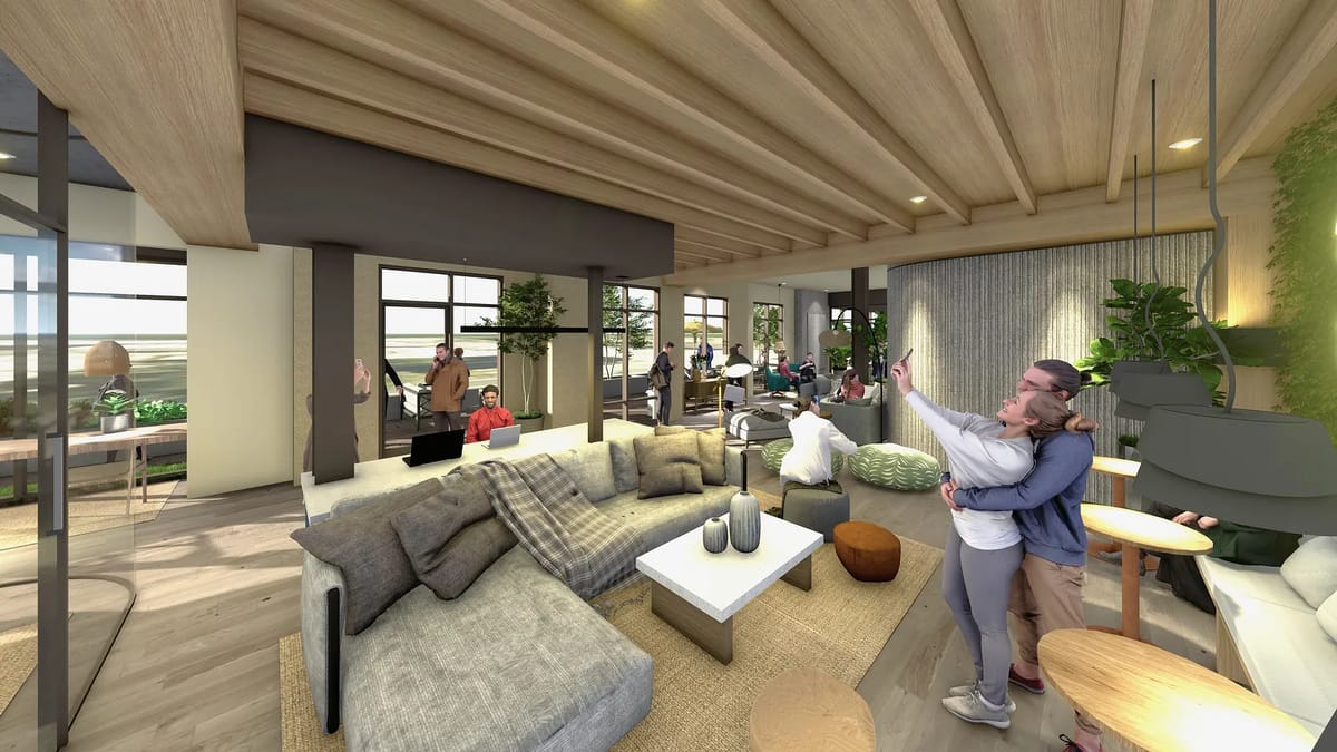 Living room with gray sectional sofa, white coffee table, plants, large windows, and wooden beams.