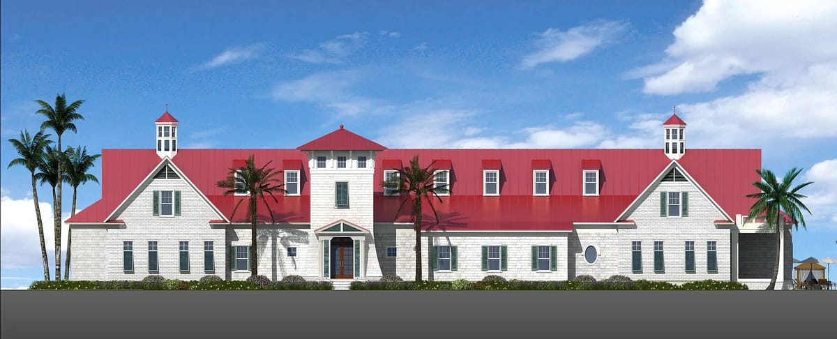 Front view of a large building with red roof, white siding, double doors, palm trees, and landscaped area.