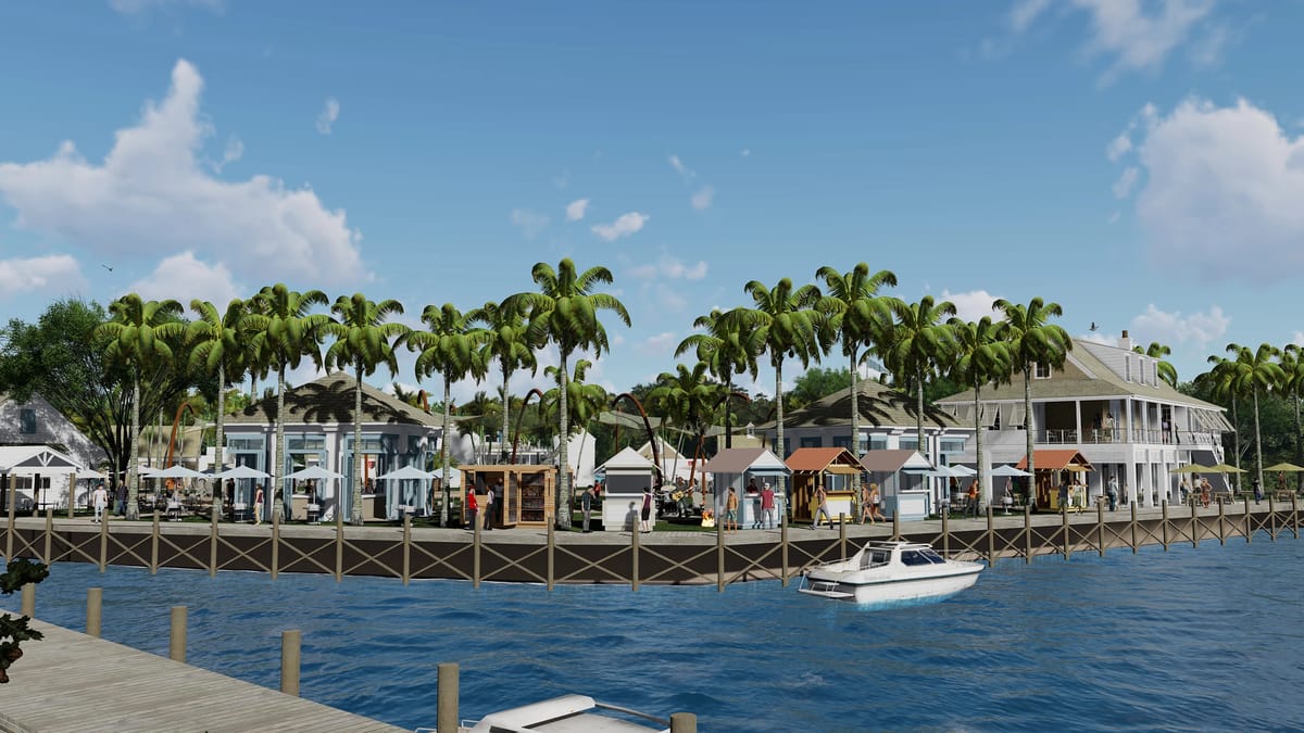 Waterfront scene with shops, seating areas, palm trees, and a boat on the water.