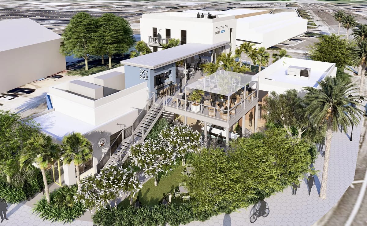 Exterior view with building complex, patio spaces, landscaping, and staircase.