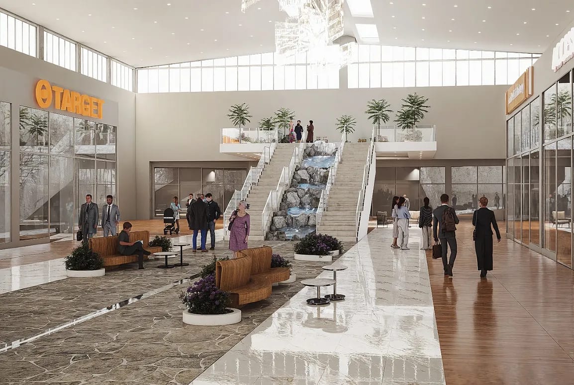 Large commercial space with polished stone floor, seating areas, escalators, and a waterfall feature.