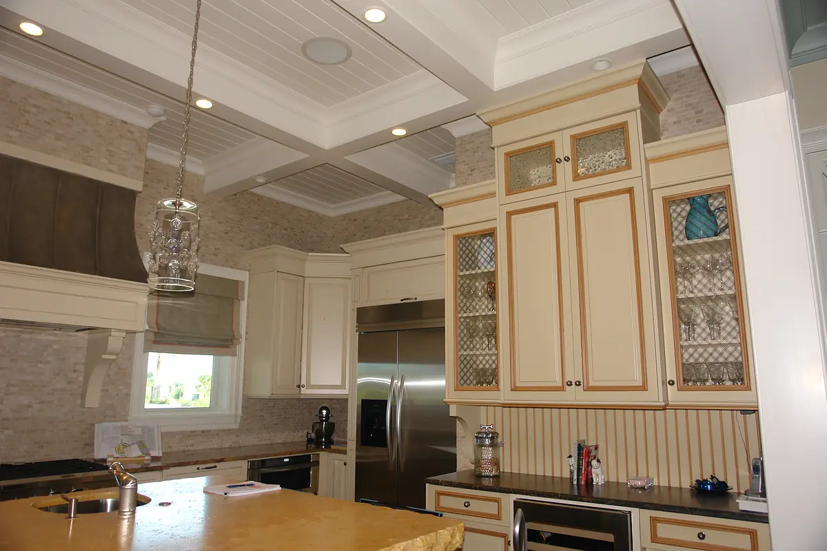 Kitchen with beige cabinets, stainless steel refrigerator, built-in oven, granite countertops, and central island.