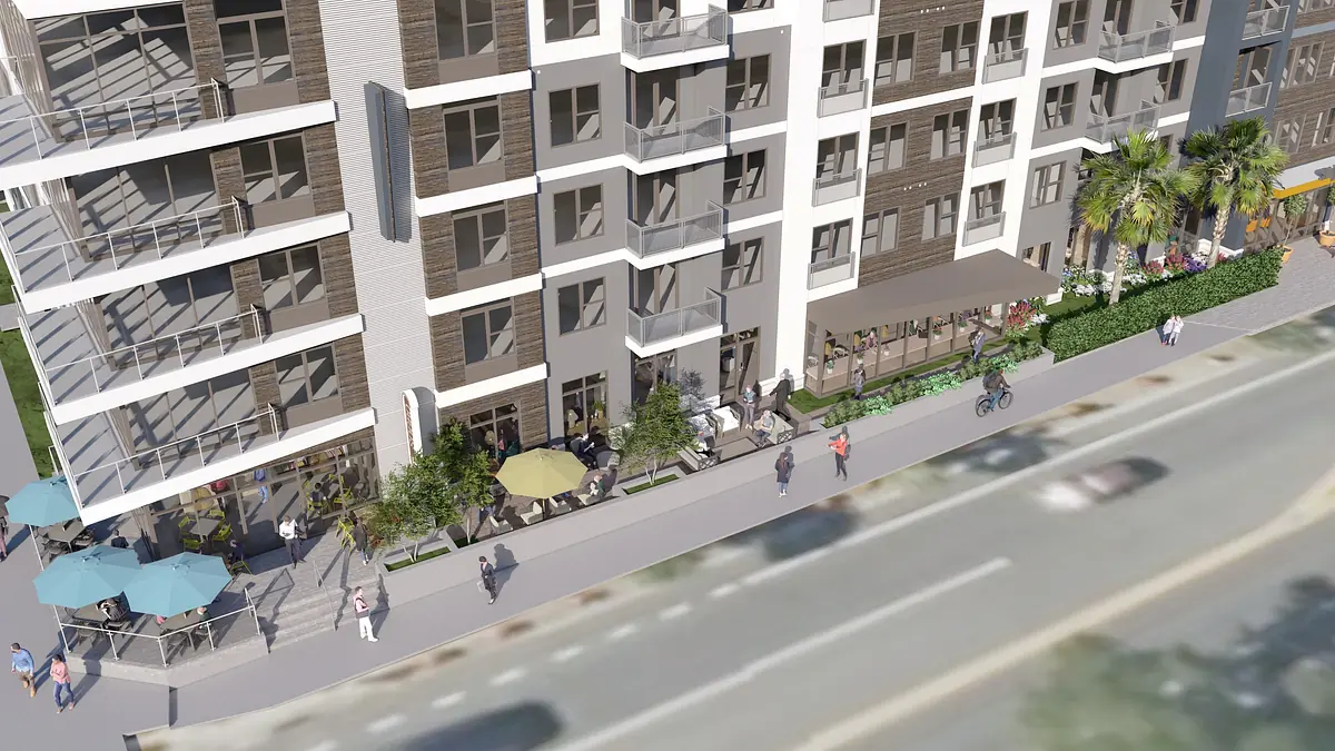 Exterior view of a multi-story building with balconies, seating areas, and landscaping.