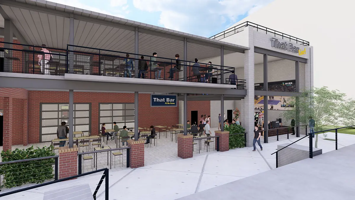 Exterior front of a building with outdoor seating, planters, and brick structure with large windows.