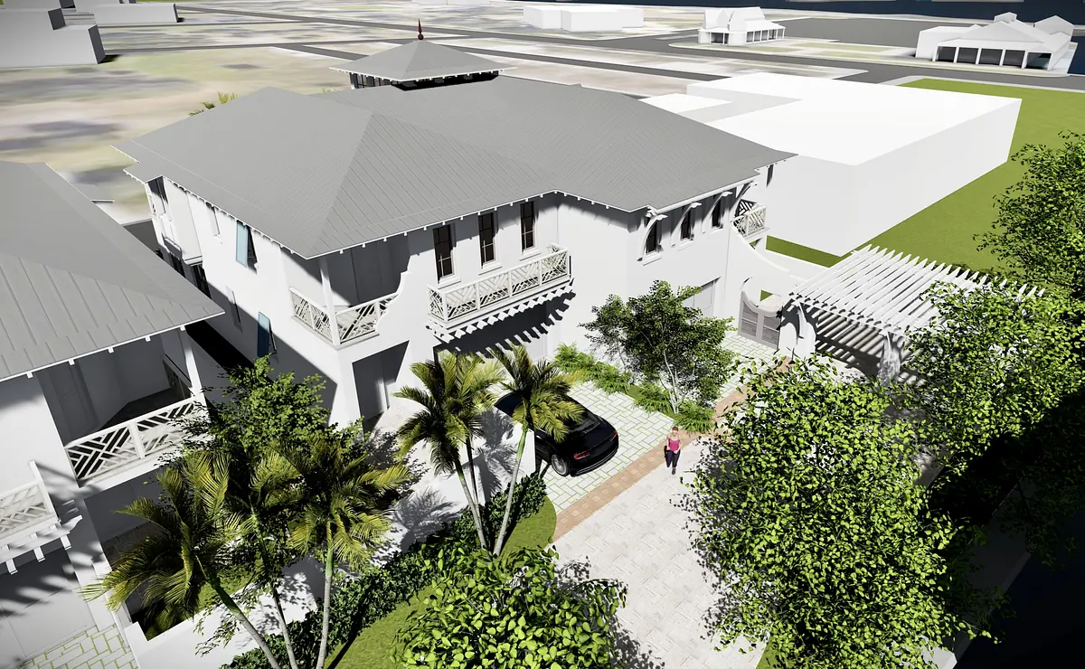 Exterior front view of a two-story house with gray roof, balconies, stone driveway, and surrounding greenery.