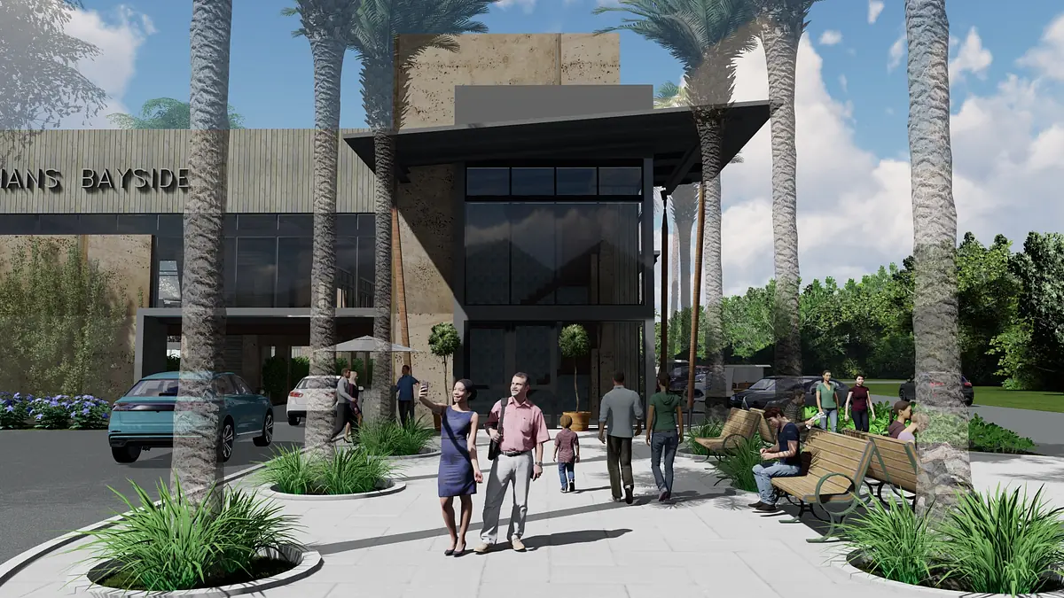 Exterior front view of a modern building with glass facade, palm trees, benches, and landscaping.